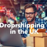 Entrepreneur with laptop and shipping materials for dropshipping.